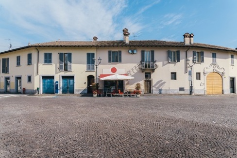 Wide angle view of a quiet street with a cafe in rural Lombardy, Italy
