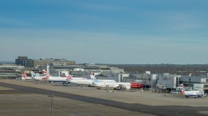 London Gatwick, March 15th, 2018: Airplanes of different airliners on tarmac awaiting passengers at London Gatwick's North Terminal